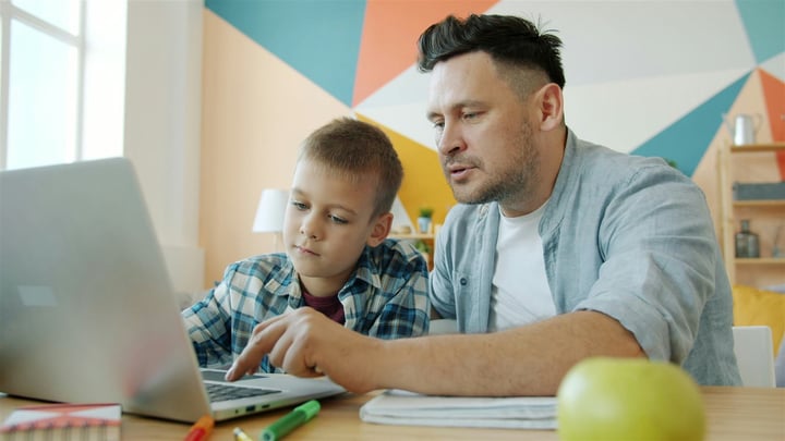 Parent staring at phone screen during registration, frustrated