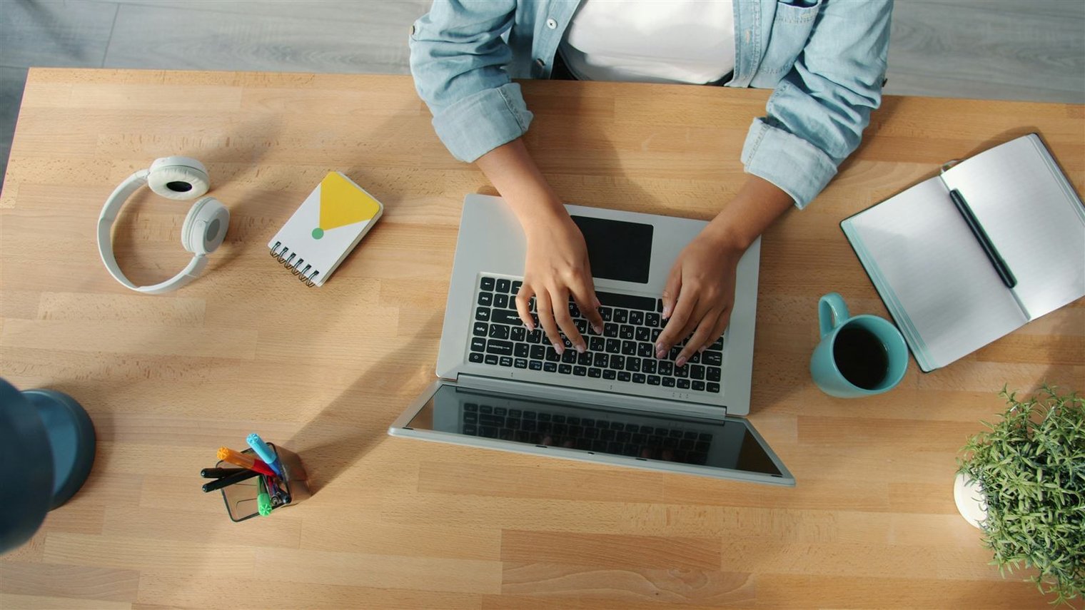 Coins and dollar bills on a desk next to a budget spreadsheet