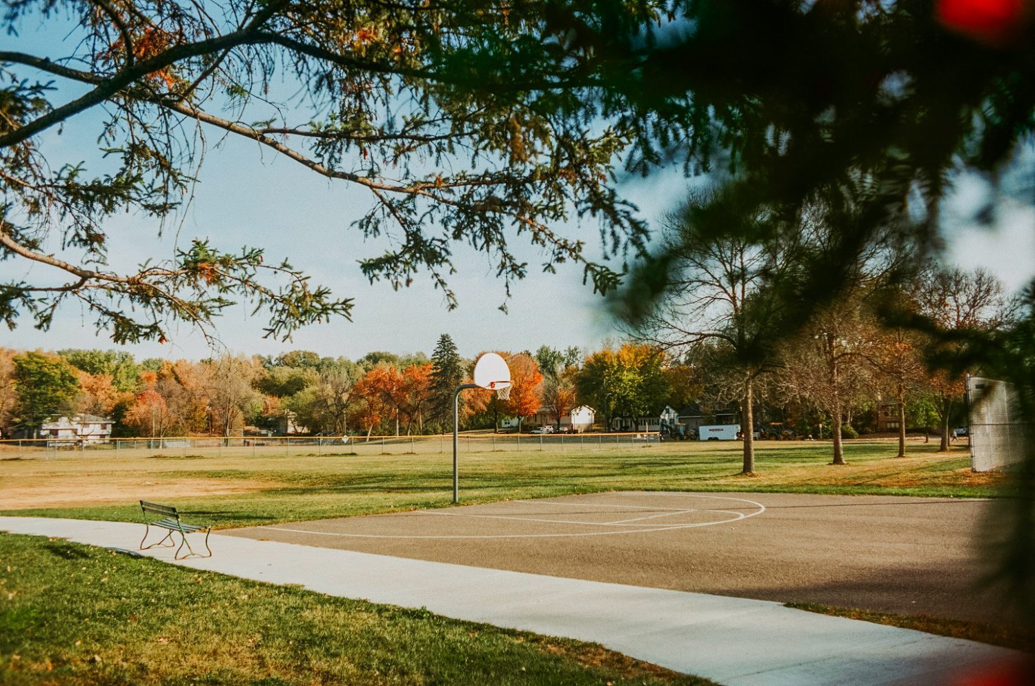 Neighborhood basketball court in an autumn park