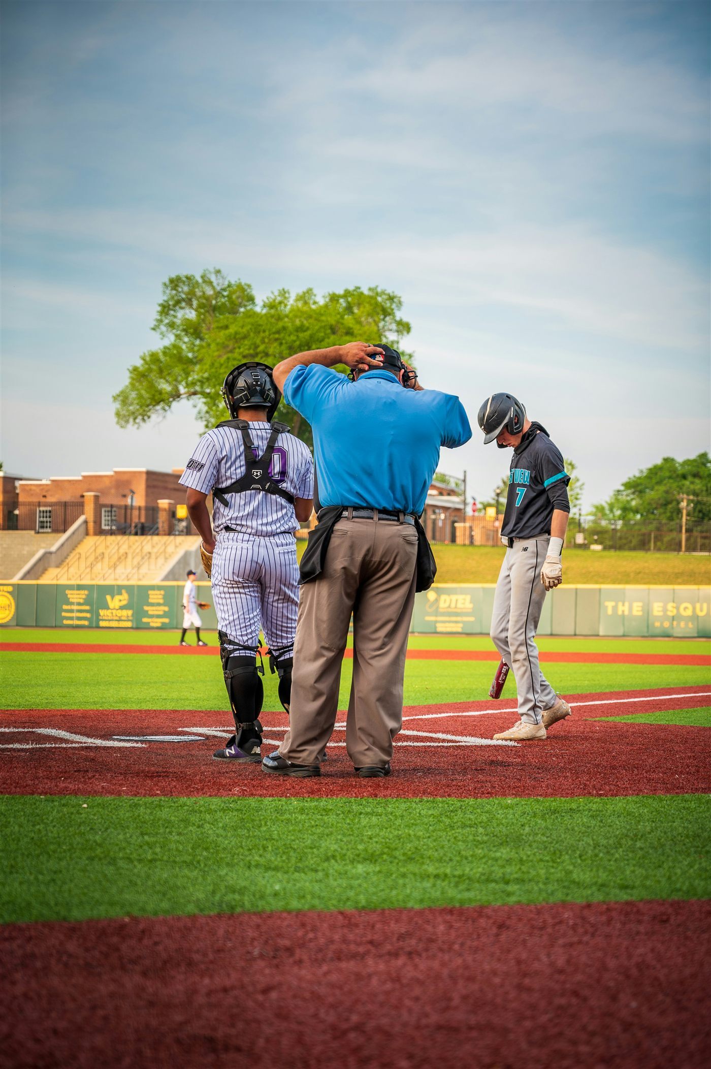 Baseball umpire and players at home plate