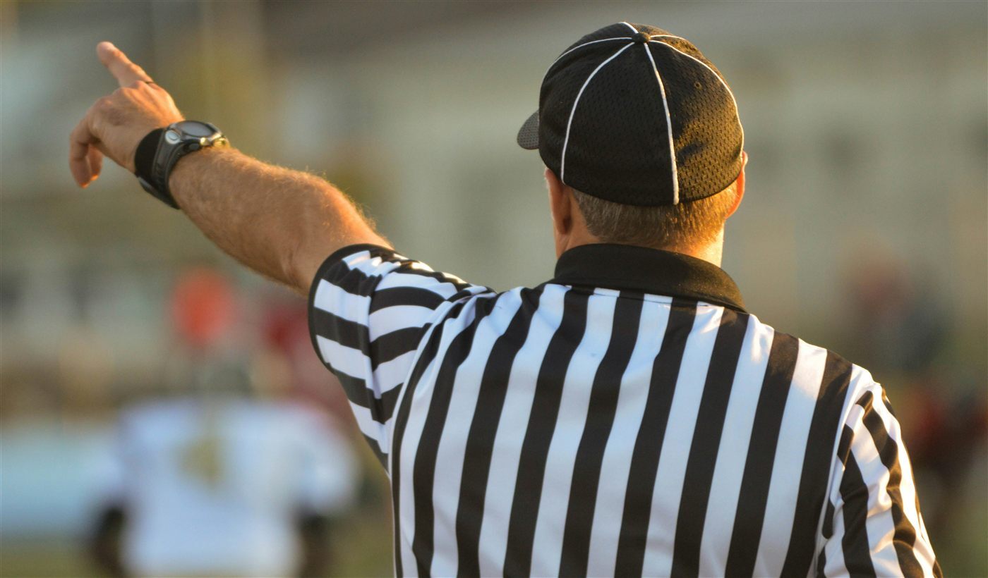 Recreation official directing play on the field